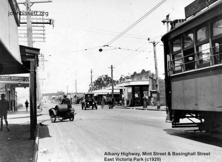 Albany Road (C1920) looking south. The junction of Mint St and Basinghall St East Victoria Park WA. Note the combination of travel, tram, motor cycle, motor car, horse drawn wagon and walking. This was a tram terminus note overhead wires. In the distance you can see the outline of the Edward Millen House.